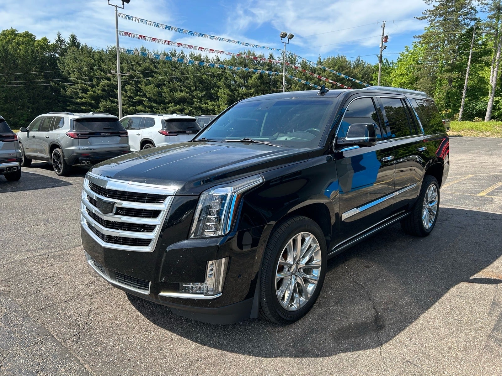 2019 Cadillac Escalade Premium Luxury in Black Raven — front three-quarter view