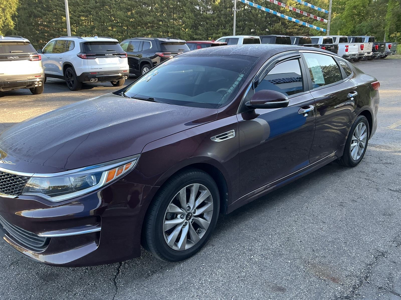2018 Kia Optima LX in Maroon — front three-quarter view
